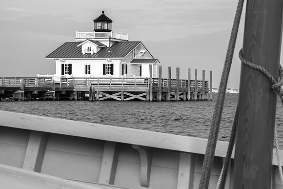 Marshes Light viewed through a hand-crafted wooden sail boat in Manteo, NC