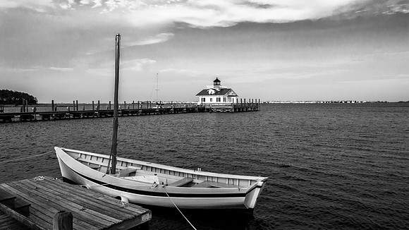 Marshes Light and a hand-crafted wooden sail boat in Manteo, NC