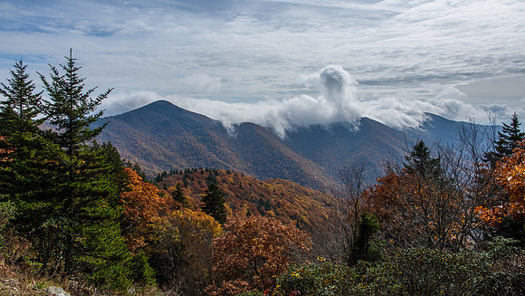 Clouds seeping over the mountain ridge, above Black Mountain