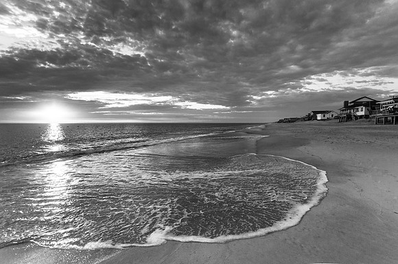 The sun bursts through the clouds in Kitty Hawk (B&W)