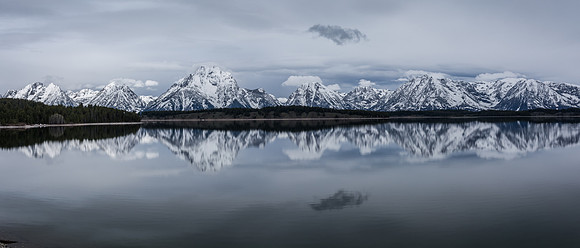 Magnificant, reflecitve view of the Grand Tetons with Jackson Lake in the foreground
