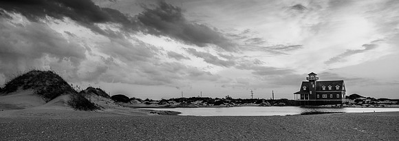 The sun sets over the historic Oregon Inlet Life Saving Service Station (B&W)