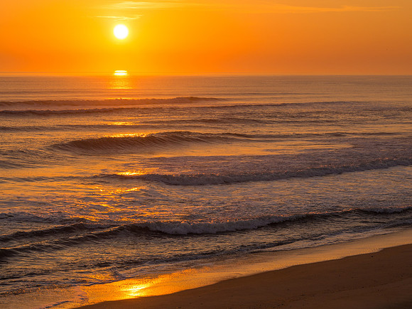 Waves and a golden glow at sunrise in Duck, NC