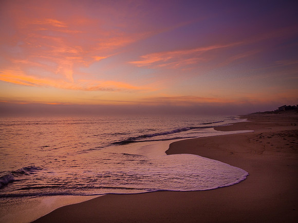 Calm seas and dramatic sky at sunrise in Nags Head, NC