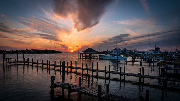 The sun sets over a tranquil Silver Lake harbor, Ocracoke, NC